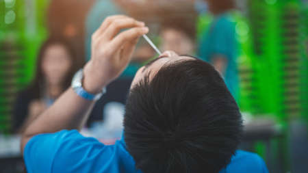 The man swab COVID-19 testing by ATK or Rapid Antigen Test kit  with a cotton nasal swabの写真素材