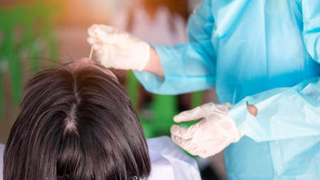 The Student swab COVID-19 testing by ATK or Rapid Antigen Test kit with a cotton nasal swabの写真素材