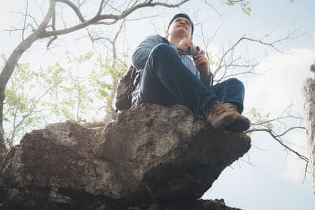 Nature photographer traveler taking photo of beautiful landscape from top of the mountainの写真素材