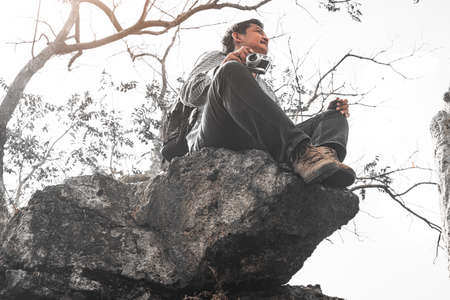 Nature photographer traveler taking photo of beautiful landscape from top of the mountainの写真素材