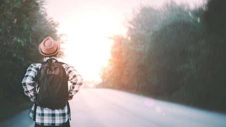 African traveler with a backpack  walking in a long road.Concept of adventure travel