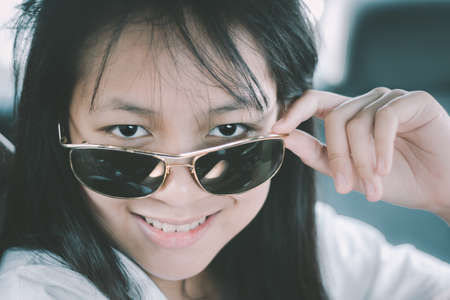 Cute little girl with vintage sunglassesの写真素材