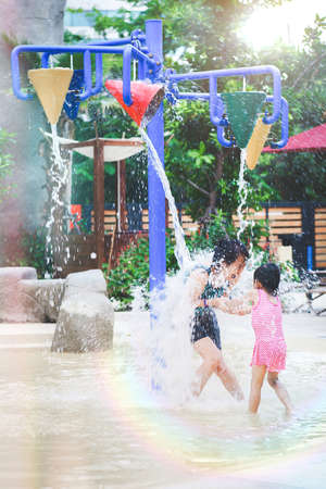 Mother and child having fun activities at the water parkの写真素材