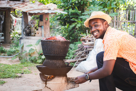African villager  cooking lunch in a rural district on the outskirts of Cape Townの写真素材