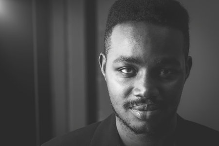 Black and white portrait of an African man looking at the camera, his eyes full of hope.Concept of Black History Monthの写真素材