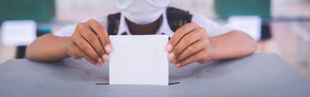 Students vote within the school using ballot papers to vote.The concept of basic democracy within schoolの写真素材