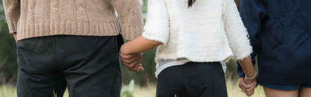 Parents holding daughter's hands supported by loving parents.Complete family conceptの写真素材