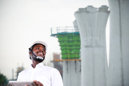 African civil engineering working with use tablet for control the road rebuilding and inspect the construction siteの写真素材