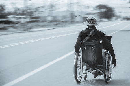 Alone man sit in a wheelchair on a highway.Black and White Styleの写真素材