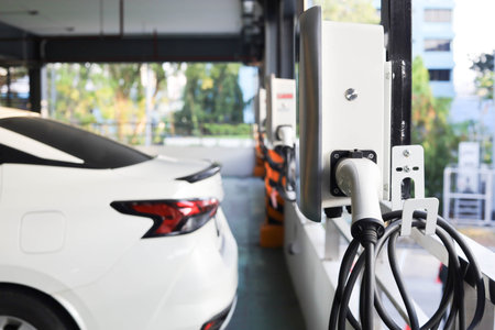 Modern electric vehicle charging station in an outdoor parking lot in the cityの写真素材