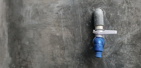 water faucet on the concrete wall