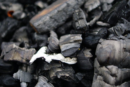 Charcoal for cooking food, closeup of black and white coalの写真素材