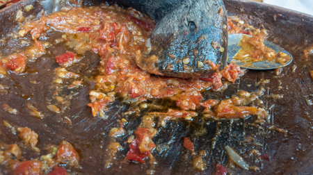 Pork stewed with tomato sauce in a pan, close upの写真素材