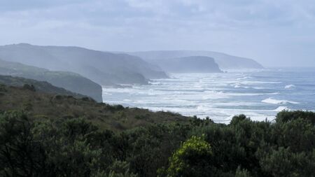 view towards cliffs in fog at the great ocean road, victoria, australiaの写真素材