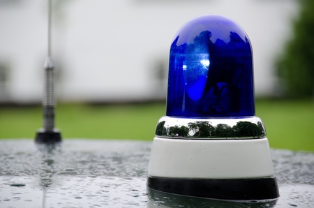 blue police light shining on an old police car in Denmarkの写真素材