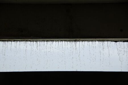 Curtain of water seen from inside a buildingの写真素材