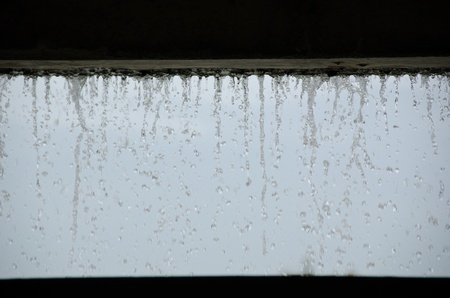 Curtain of water seen from inside a buildingの写真素材