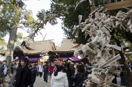 New years day Japanese going to the Sumiyoshi-Taisya Grand Shrine in Osaka, Japan. With omikuji in the foregroundのeditorial素材