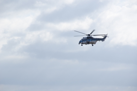 Japan Coast Guard Helicopter flying in front of a cloudy skyのeditorial素材