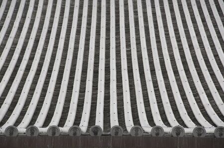 Detail of a japanese roof with traditional roofing tilesの写真素材