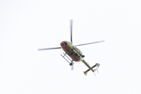 ADAC rescue helicopter seen from below flying のeditorial素材