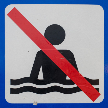 Closeup of a no bathing sign at the coast of Denmarkの写真素材