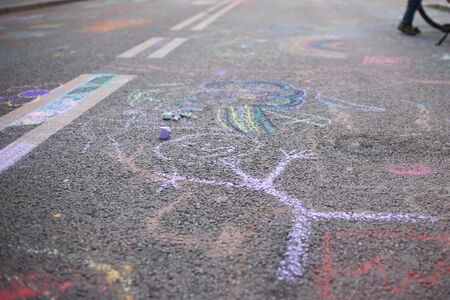 Children's drawing with chalk on a street with purple chalkの写真素材