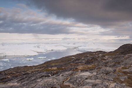 Landscape in Ilulissat, Greenland, with icebergs and coastline