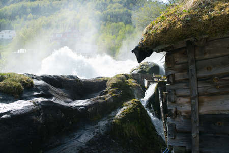Old wooden watermill and waterfallの写真素材