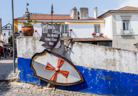 Obidos, Portugal - May 18, 2018: Sign pointing to a bar in the medieval town of Obidos, Portugalのeditorial素材