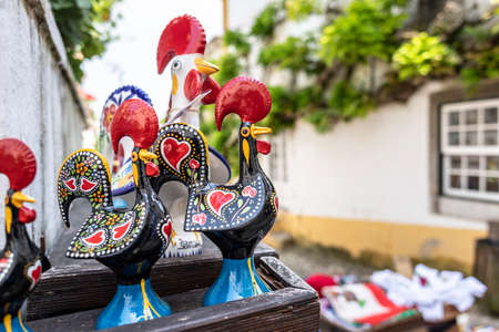 Obidos, Portugal - May 18, 2018: Rooster figurines in a tourist shop in the medieval town of Obidos, Portugalのeditorial素材