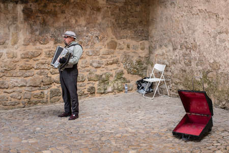 Obidos, Portugal - May 18, 2018: A street musician plays his accoredeon in the medieval town of Obidosのeditorial素材