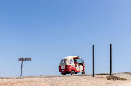 Nazare, Portugal - July 18, 2019: A small electric car takes tourists back and forth to the Nazare lighthouseのeditorial素材