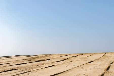 Minimalistic image with blue sky and sand