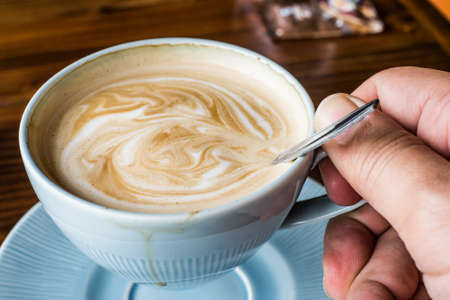 Hot Coffee Latte on wooden tableの写真素材