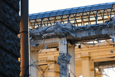 Demolished destructed building ruins. Demolition site in european city. Ruined house on a bright...