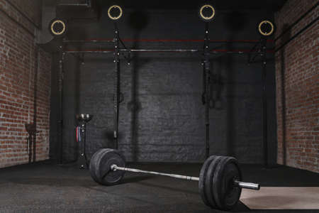 Workout gym with cross fit equipment. Barbell horizontal bars gymnastic rings.の写真素材