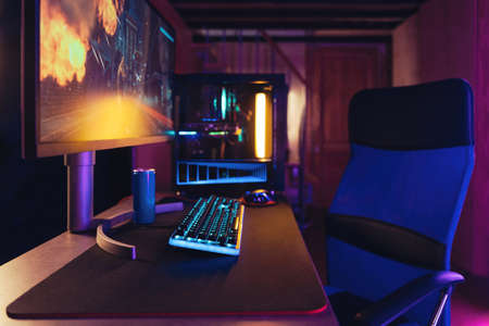 Professional gaming PC setup in neon roomの写真素材