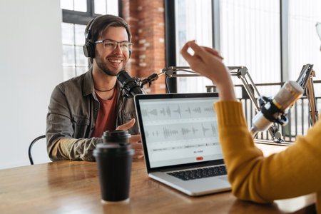 Two radio hosts recording audio podcast in studioの写真素材