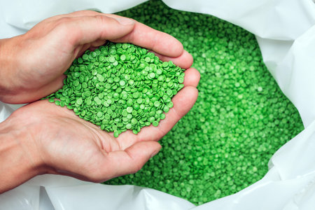 hands hold or touching biodegradable plastic pellets, plastic polymer granulesの写真素材