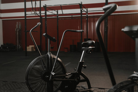 Exercise bikes for cardio in red color crossfit gym. Air bikesの写真素材