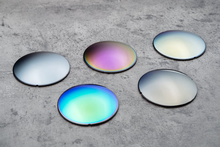 Close up of optical lenses for sunglasses with different color. Production and adjust of new...