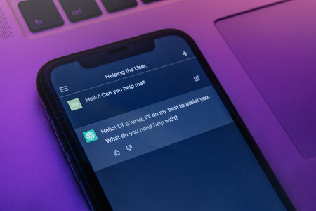 Antalya, Turkey - May 8, 2023: Dialogue with ChatGPT chatbot on smartphone screen in neon light. ChatGPT powered by Open AIs Open AIs innovative artificial intelligence technology.のeditorial素材