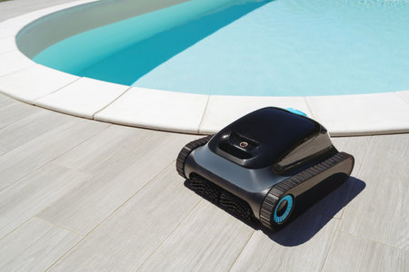 A robotic pool cleaner in front of a outdoor swimming pool with bright blue water, ready for efficient underwater cleaning and debris removal. Space for textの写真素材