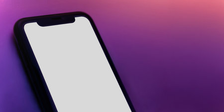 Smartphone mock up with white blank screen on vivid neon tones background. Web banner of mobile phone for digital product and apps showcase with copy space.の写真素材