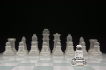 A pawn standing alone against the other team.の写真素材