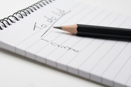 Close up of  a pencil and a notepadの写真素材