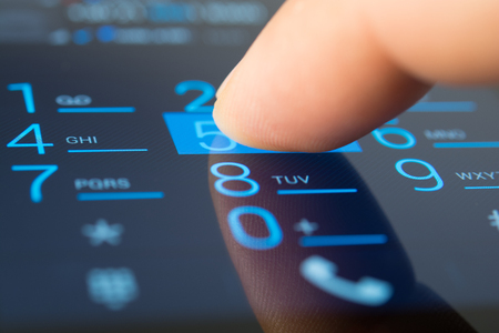 Making a dial on a smartphone close upの写真素材