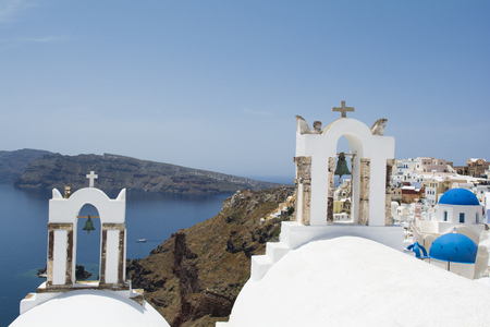 Traditional white church belfries in Oia, Santorini, Greeceの写真素材