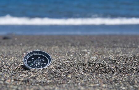 Compass on the seashore. Focus on compassの写真素材